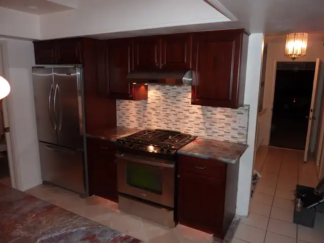 Garden Grove kitchen remodel with cherry cabinets, glass mosaic backsplash and stainless gas range